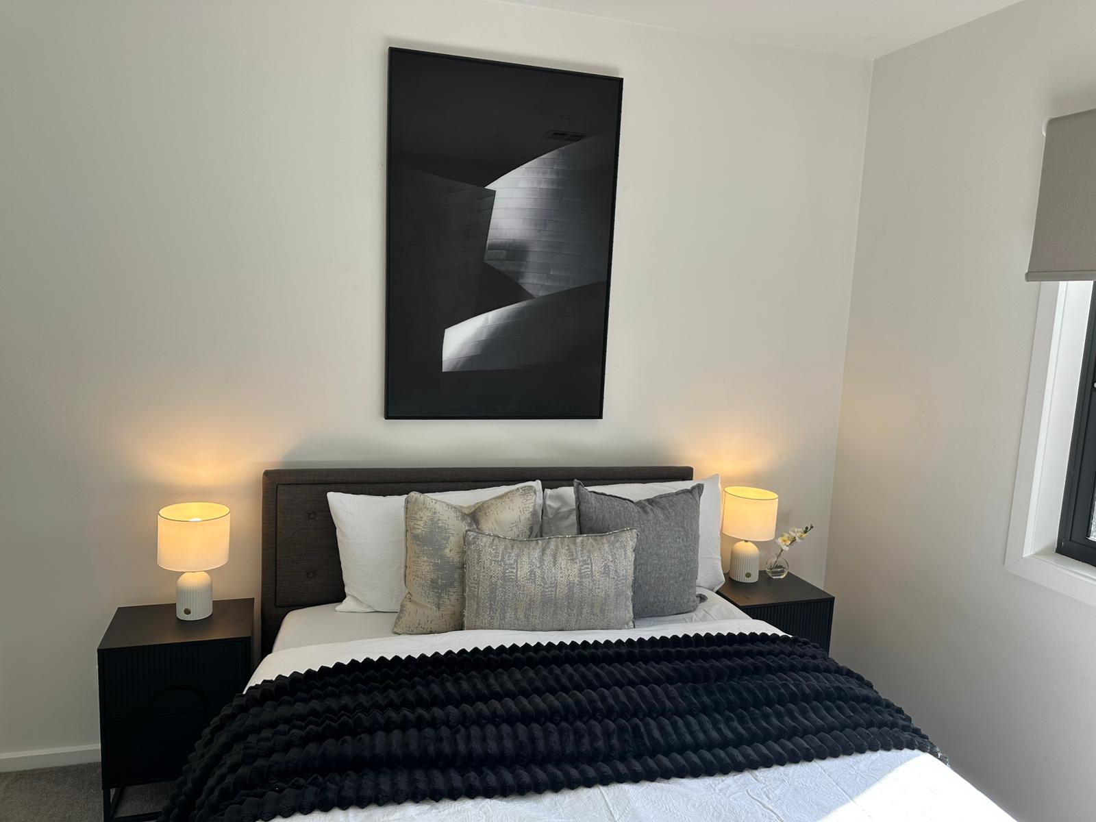 Property styling vignette with cushions, decor, and artwork